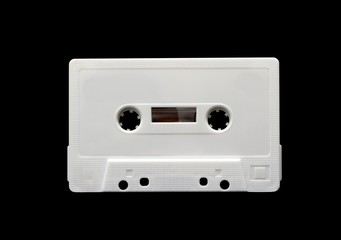White audio cassette isolated on black background