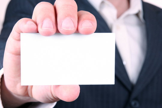 man is holding a business card