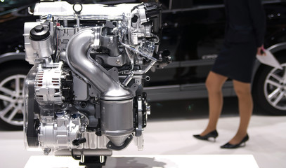 car engine with woman legs and a car on background