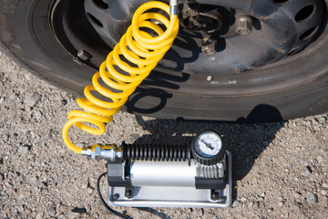 inflating tire by the electric pump on the roadside