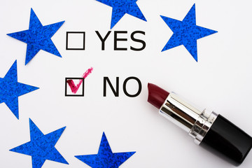Paper with boxes with the words yes and no with lipstick, voting