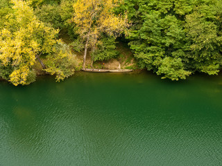 Nice green river with trees and two old boats