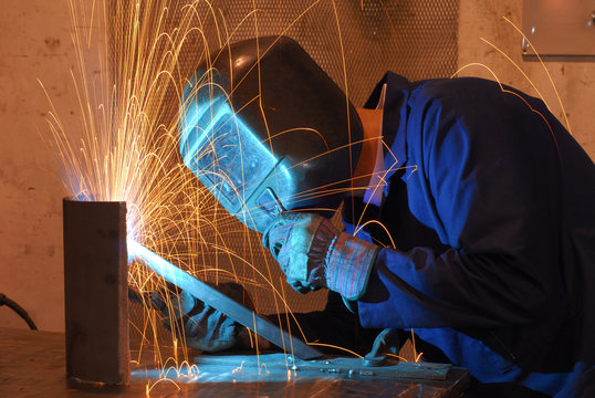 Factory welder doing his hard job