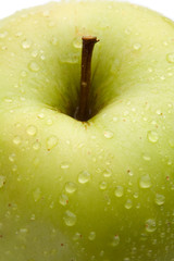 Macro of green delicious apple on a white background
