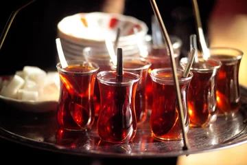 Foto op Plexiglas A man serving Turkish tea with a tray © jokerpro