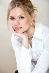 Young beautiful businesswoman with blond hair and blue eyes