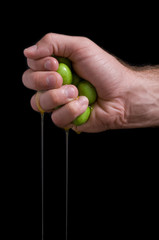 hand squeezing olives