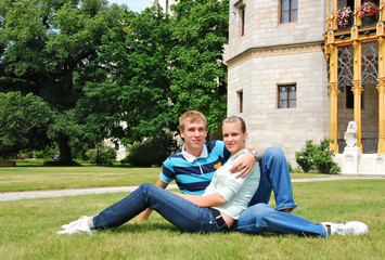 girl and boy sitting on grass