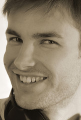 Fototapeta premium portrait of young guy which looks in chamber and smiles,