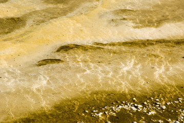 colorful abstract pattern in a thermal pool in a geyser basin