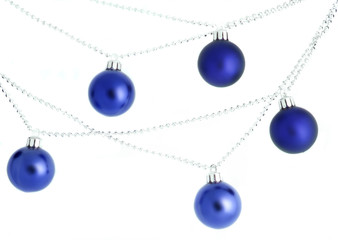 blue hanging christmas ornaments and beads on white background