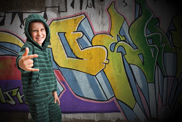Cool kid standing in front of a graffiti wall