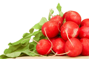 bunch of radishes on wooden plate