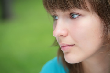 close-up portrait green-eyed girl in profile with copy-space