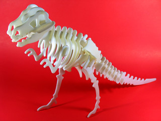 Tyrannosaurus-rex model isolated on red background