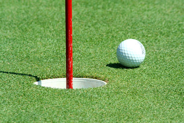 A Golf ball near the cup