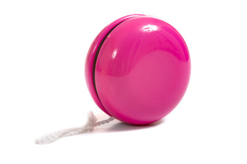 A child's pink yo-yo on a white background with copy space