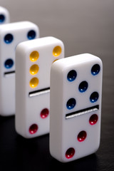 Dominos lined up in a row on a grey background