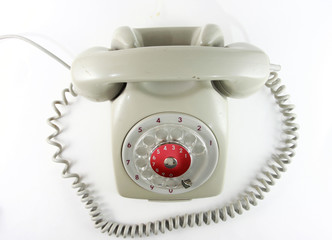 Old analog antique grey telephone with dial wheel, non digital