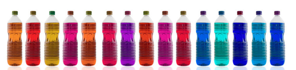 Bottles of oil of different colors lined up isolation