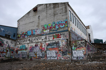 Condemned builiding during demolishion, grafiti on the walls.