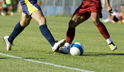 Soccer players running after the ball