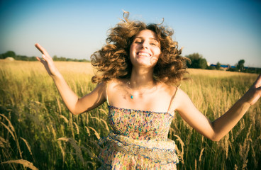 Happy jumping woman. Soft evening colors.