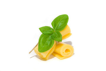 yellow cheese roll with green basil leaves