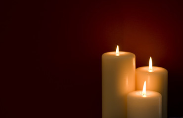 Three candles on a red background