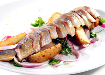 Sliced Fish Served with Baked Potatoes, Green and Onion