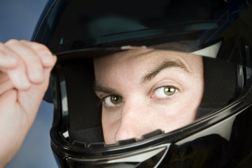 Close-up of a man wearing a motorcycle helmet