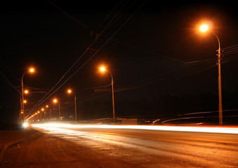 traffic ob night road with street lamps in fog