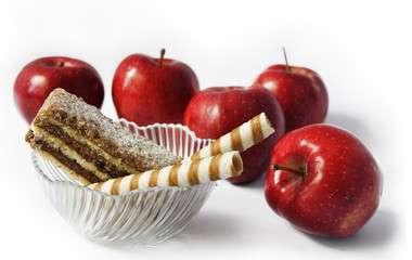 Red apples Cakes in bowl and red apples on white background