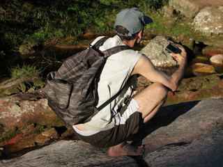 Tourist squatted with camera.