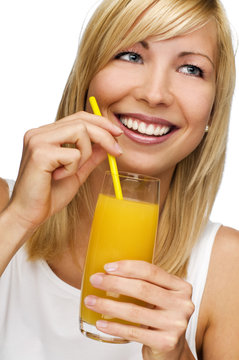 young blond woman drinking orange juice close up
