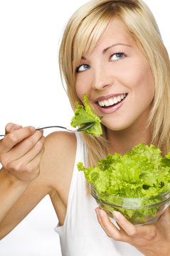 young attractive woman eating salad close up