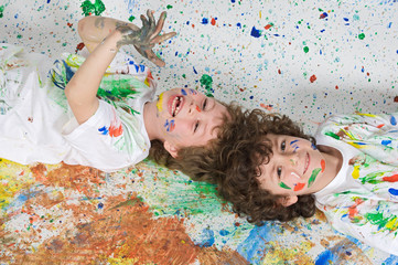 Children playing with painting with the background painted