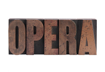 the word 'opera' in old, ink-stained wood type