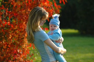 mother and child on autumn background
