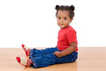 Naklejka premium Adorable african baby sit over wooden floor