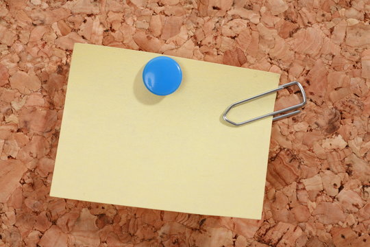 a pinboard with thumtacks on it...........