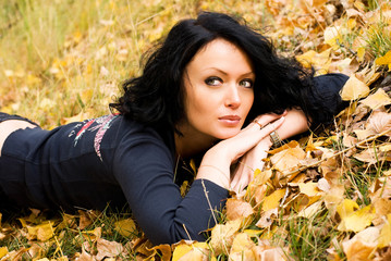 beautiful thoughtful girl on the grass in the park