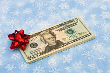 Twenty dollar bills with red bow , gift of money