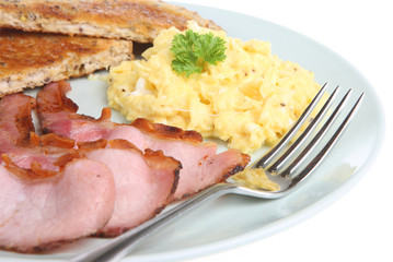 Scrambled eggs with grilled back bacon and toast