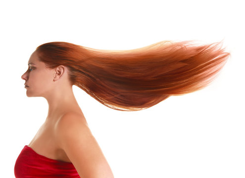 Attractive woman with her long red hair being blown back