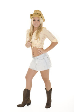 Beautiful and sexy Caucasian cowgirl on white background