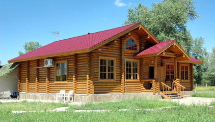 Porch of the big wooden house combined from logs.