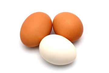 Three chicken eggs on a white background largly