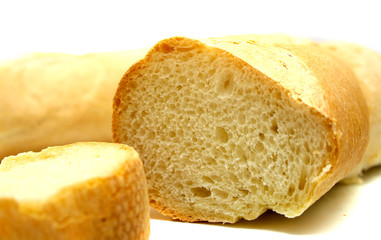 Fresh tasty bread which is cut on a part. Isolation on white.