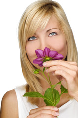 young blond woman smelling flowers close up